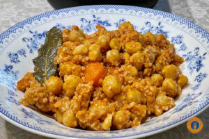 Chickpeas in Tomato Sauce with xinohondros and cumin - Gastronomy Tours chickpeas in a plate